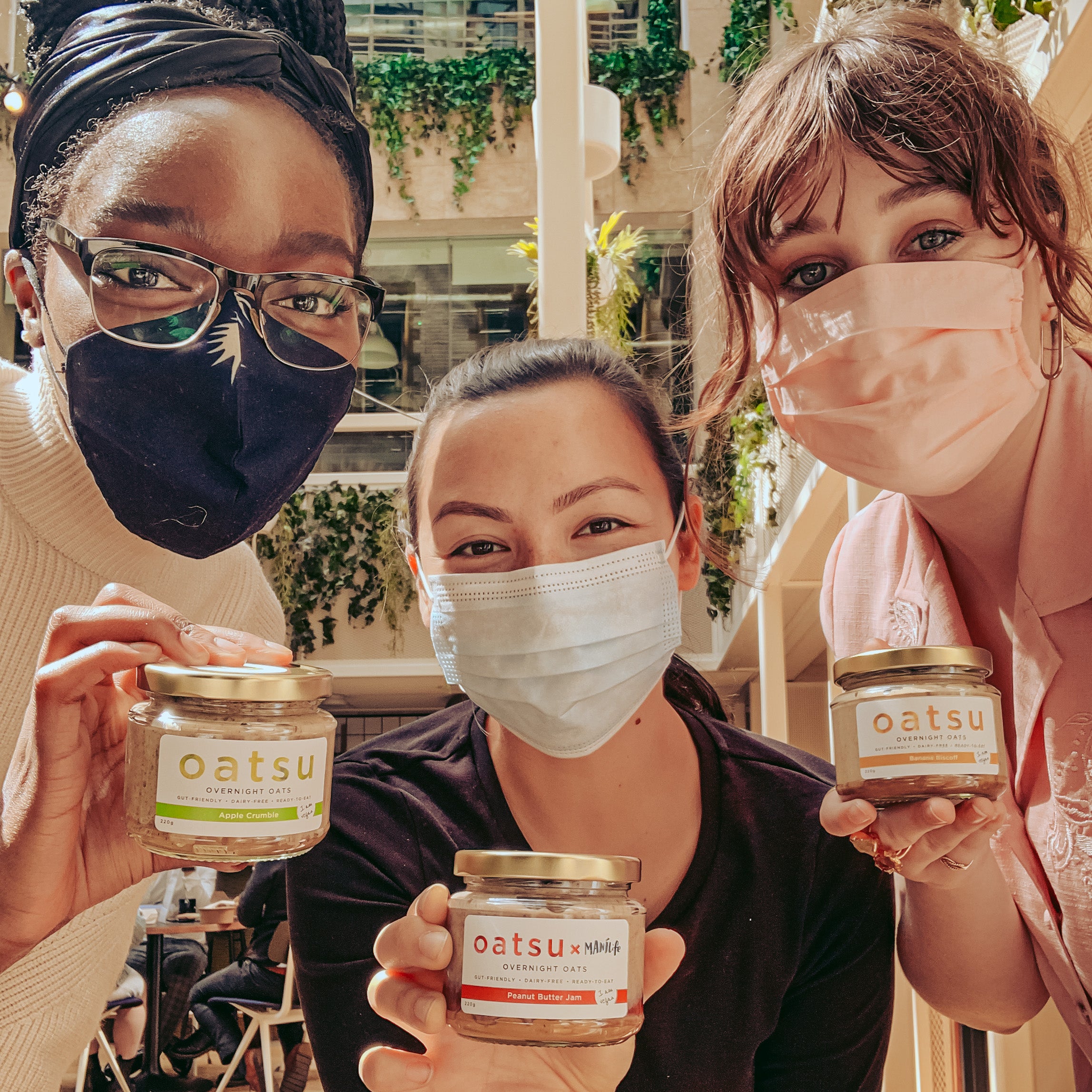 three girls posing with oats jar